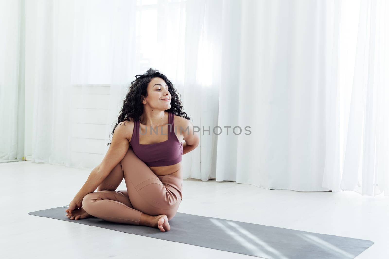 Beautiful female brunette sports yoga fitness asana body flexibility by Simakov