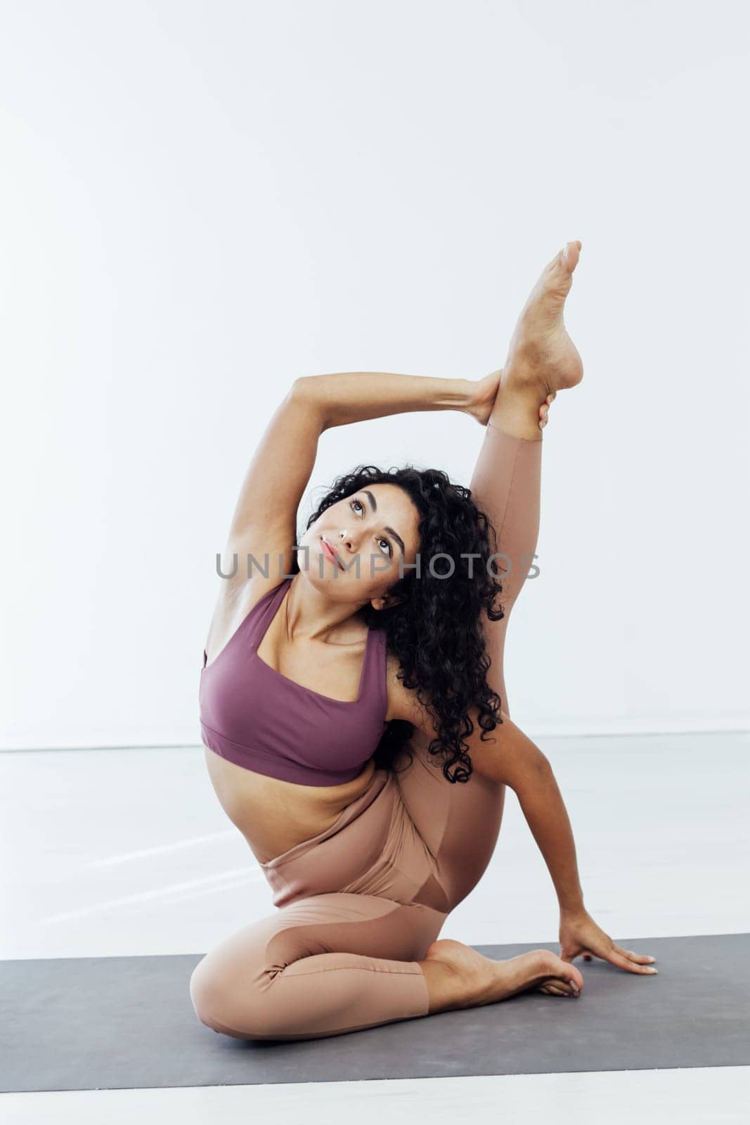 Beautiful female brunette sports yoga fitness body flexibility