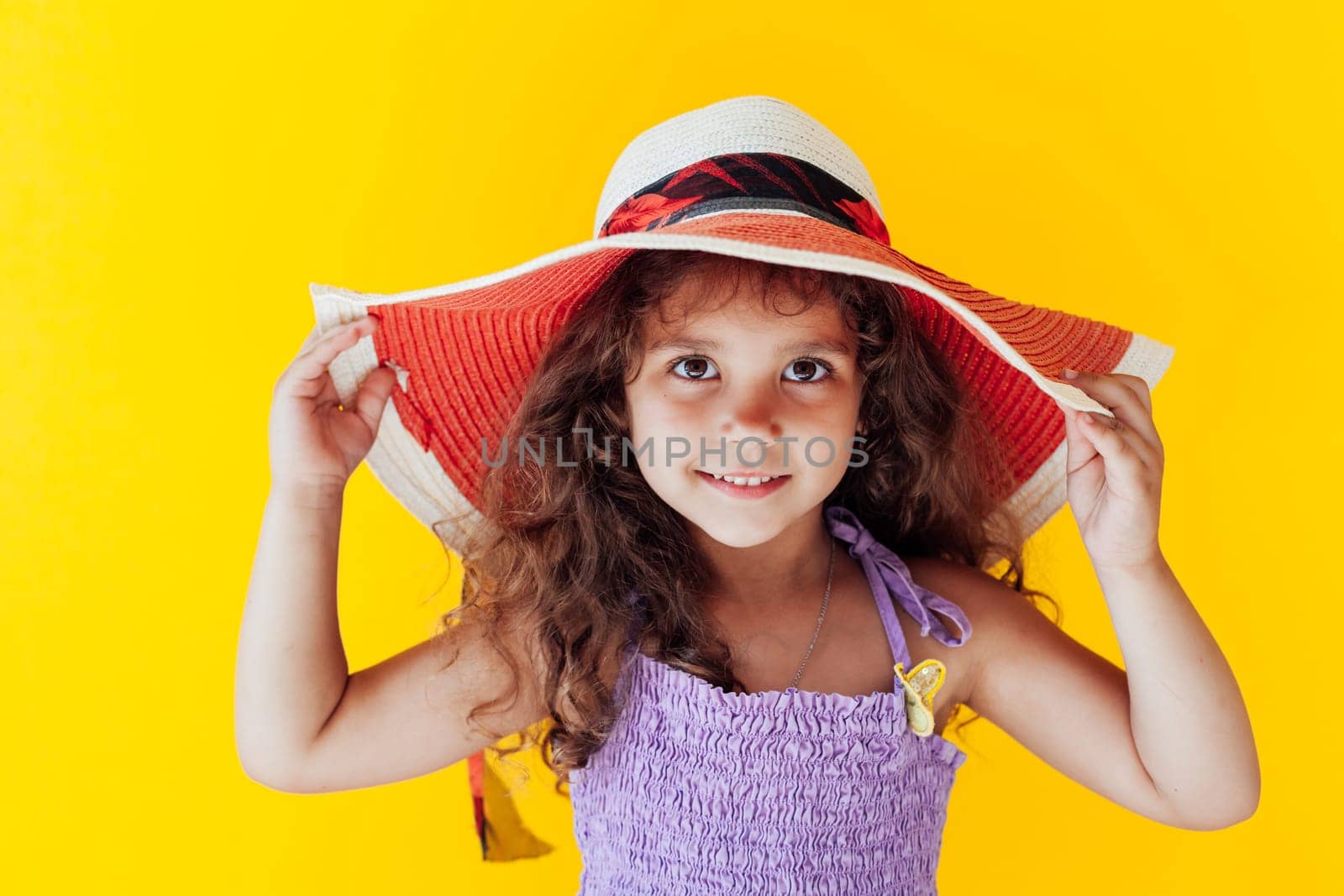 curly fashionable girl in a hat with fields