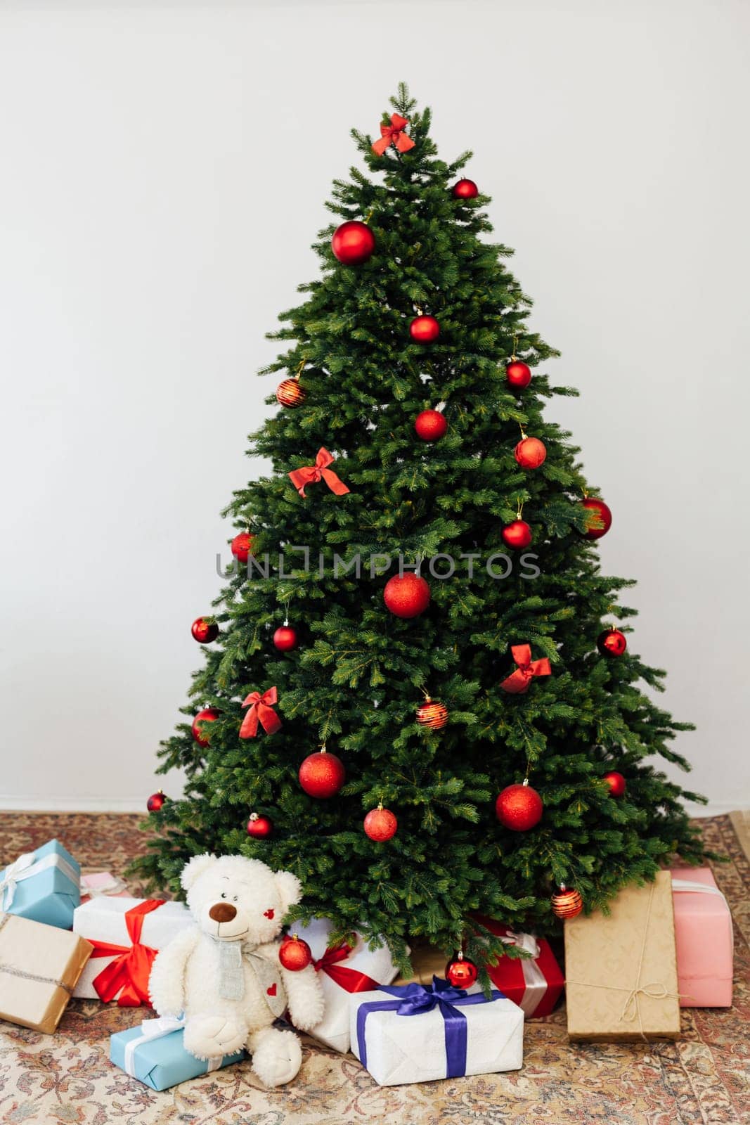 Beautiful holdiay decorated room with Christmas tree with presents under it.