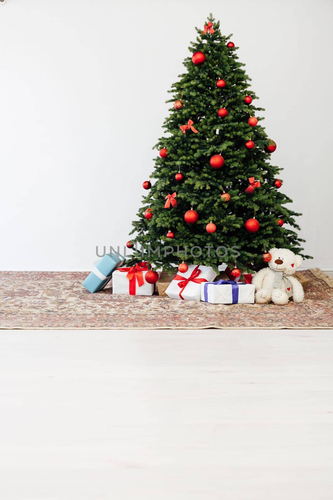 Beautiful holdiay decorated room with Christmas tree with presents under it.