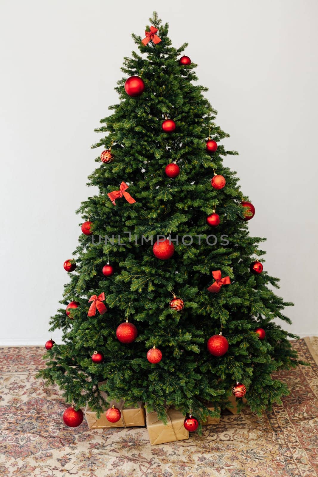 Beautiful holdiay decorated room with Christmas tree with presents under it.