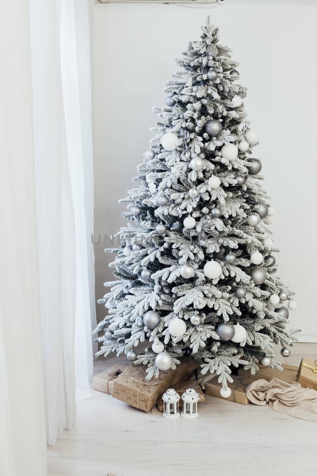 Home interior. A room with a beautiful snowy Christmas tree