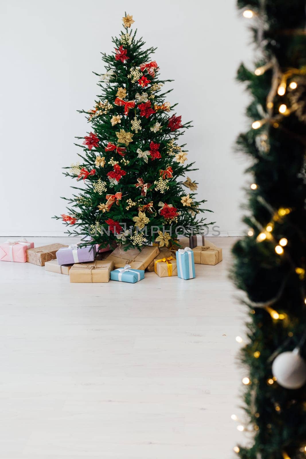 Beautiful holdiay decorated room with Christmas tree with presents under it