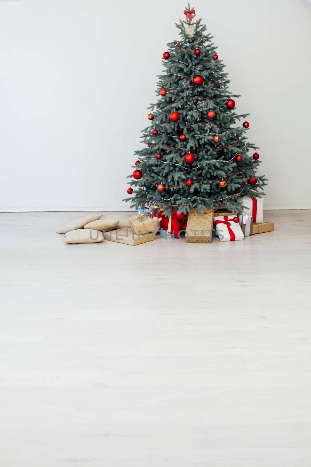 Beautiful decorated room with Christmas tree with presents under it