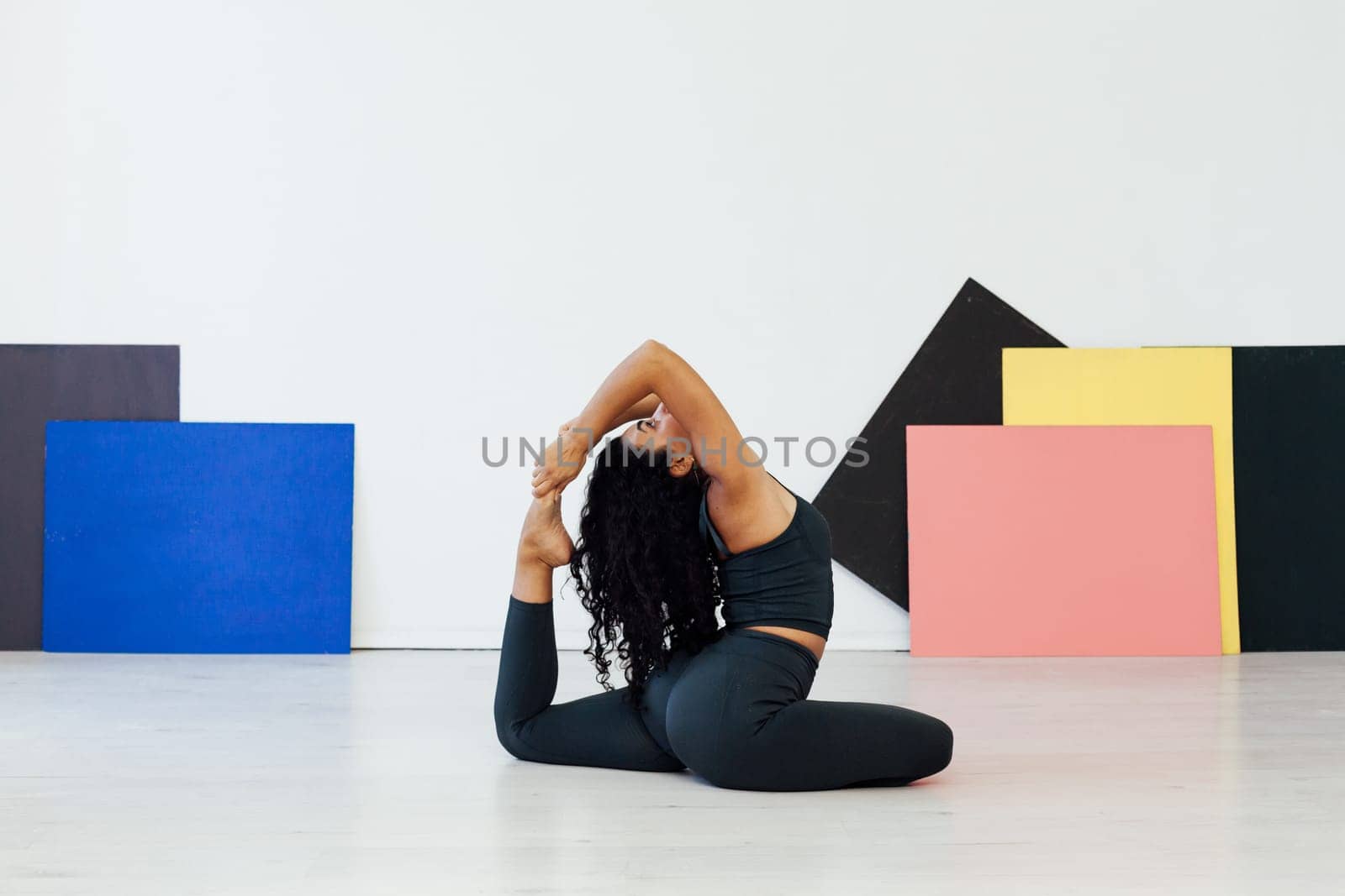 brunette woman engaged in yoga asana gymnastics fitness flexibility body