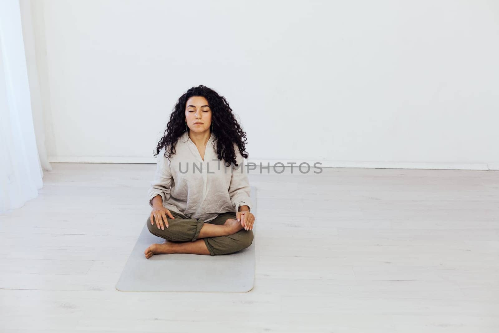 Female brunette engaged in yoga asana gymnastics sport by Simakov