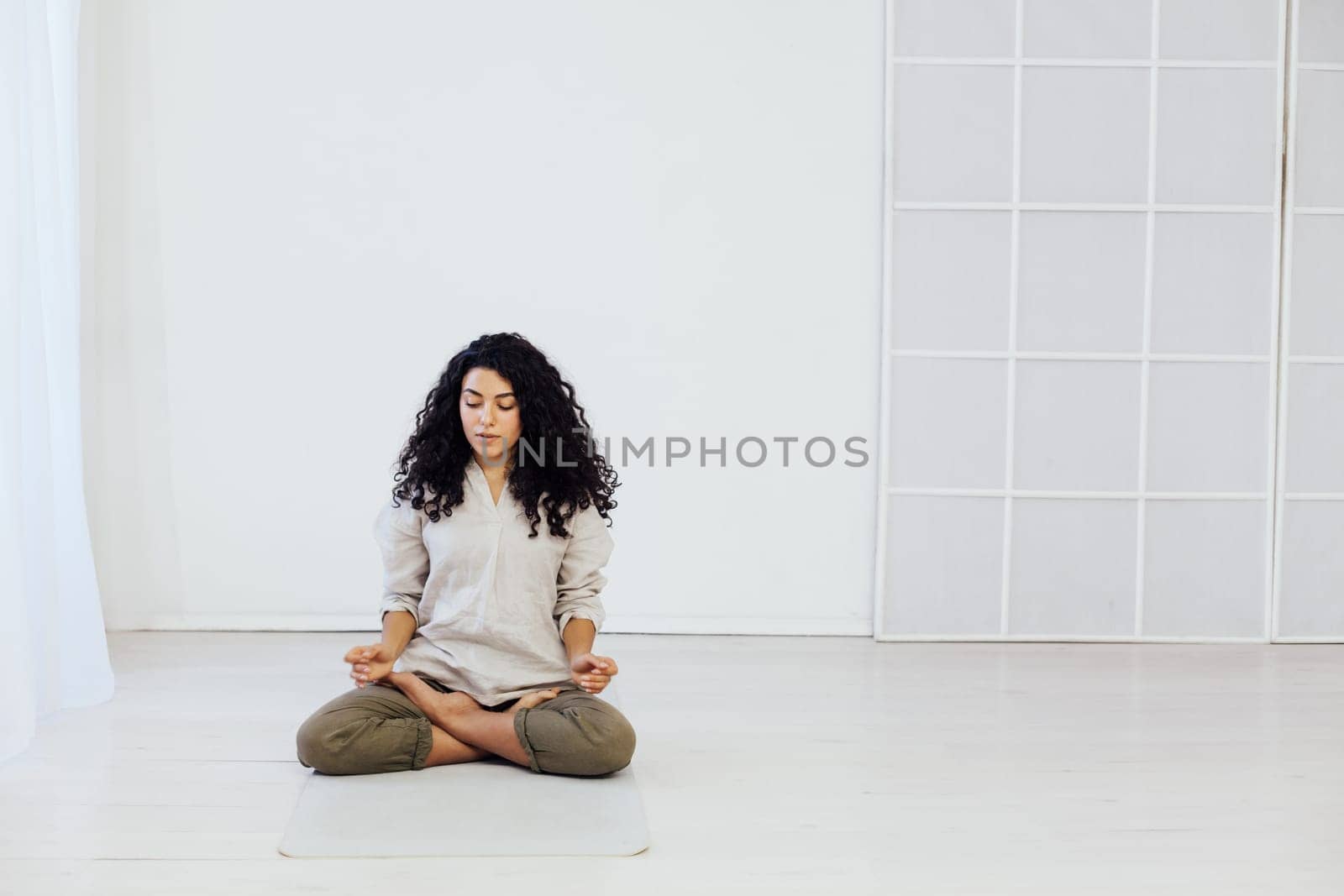 Female brunette engaged in yoga asana gymnastics sport by Simakov