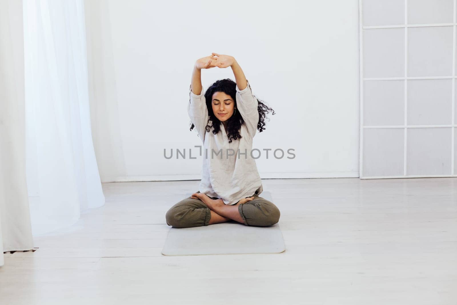 Female brunette engaged in yoga asana gymnastics sport by Simakov