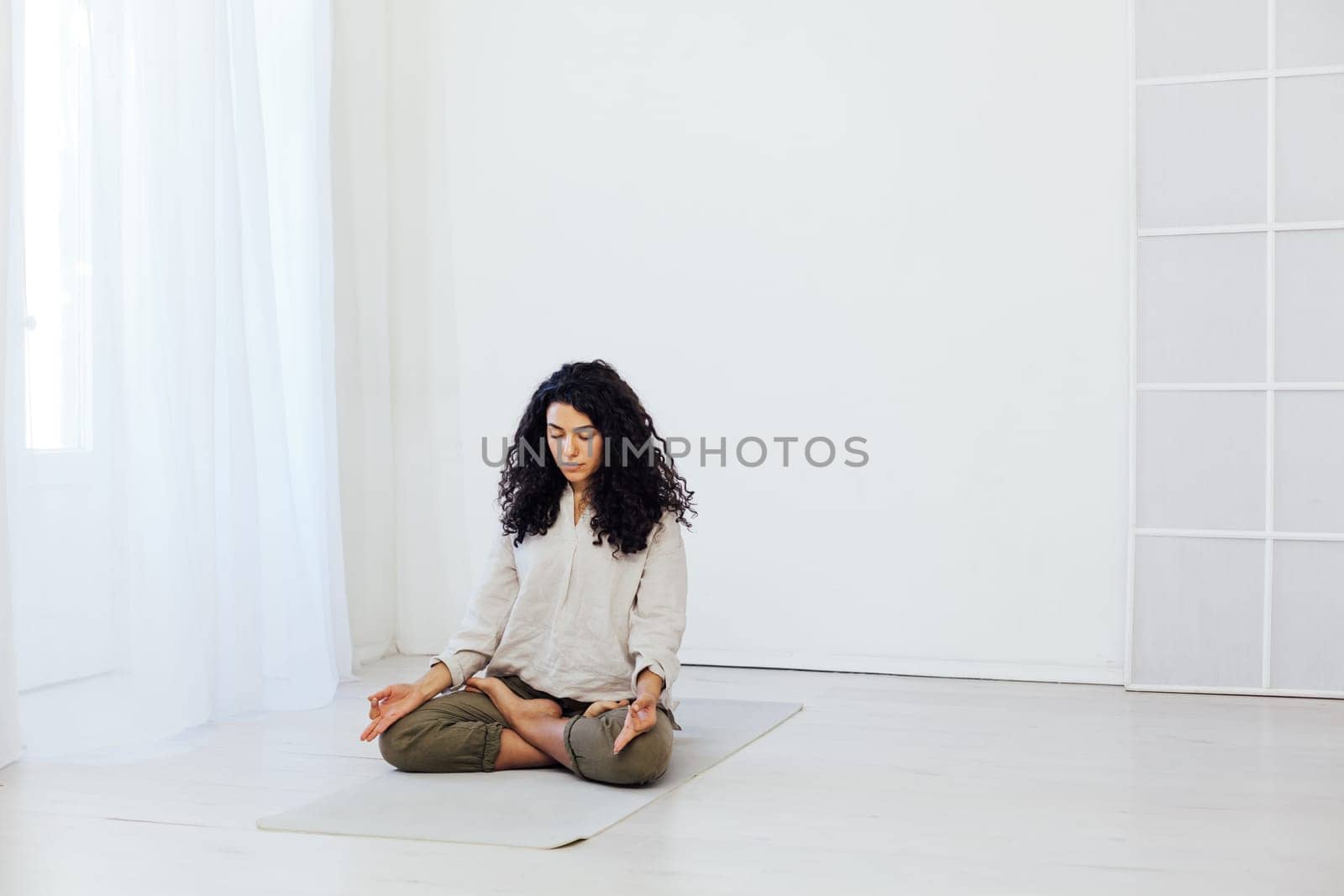 Female brunette engaged in yoga asana gymnastics sport by Simakov