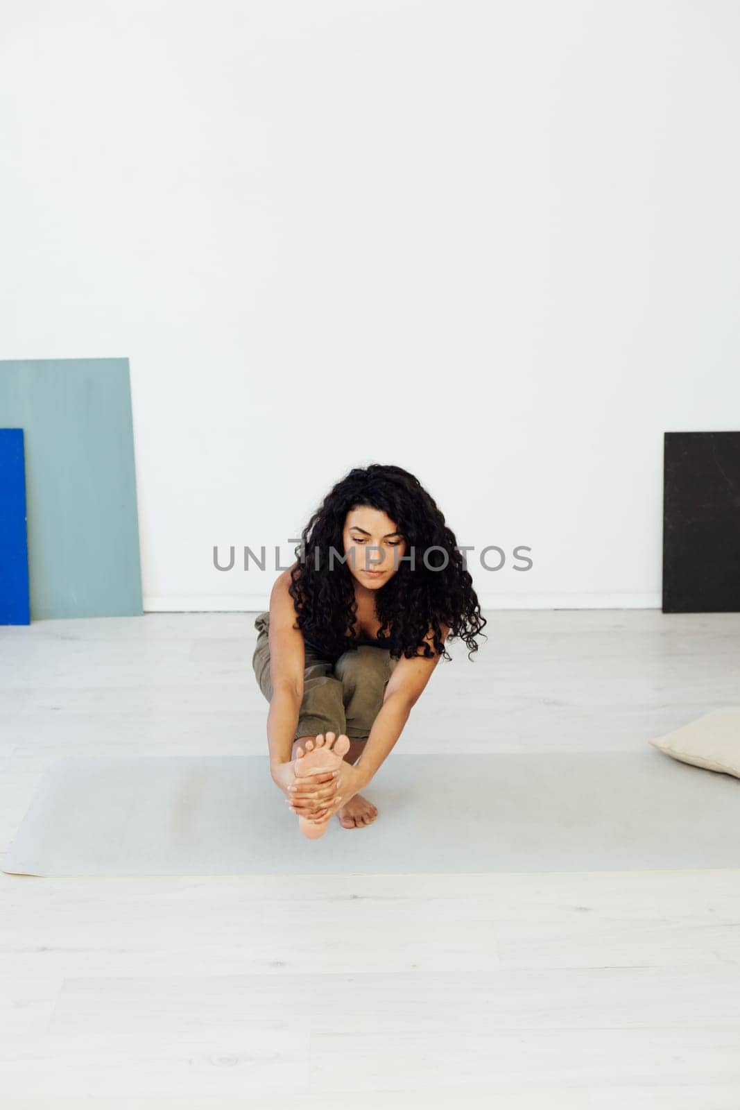 Sporting woman yoga asana gymnastics flexibility body by Simakov