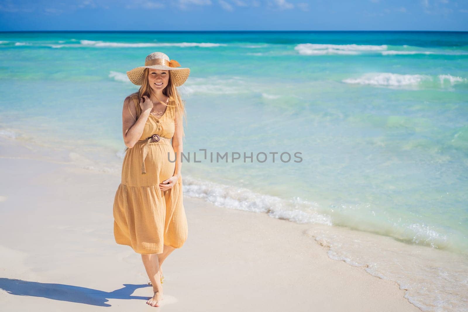 Radiant and expecting, a pregnant woman stands on a pristine snow-white tropical beach, celebrating the miracle of life against a backdrop of natural beauty by galitskaya