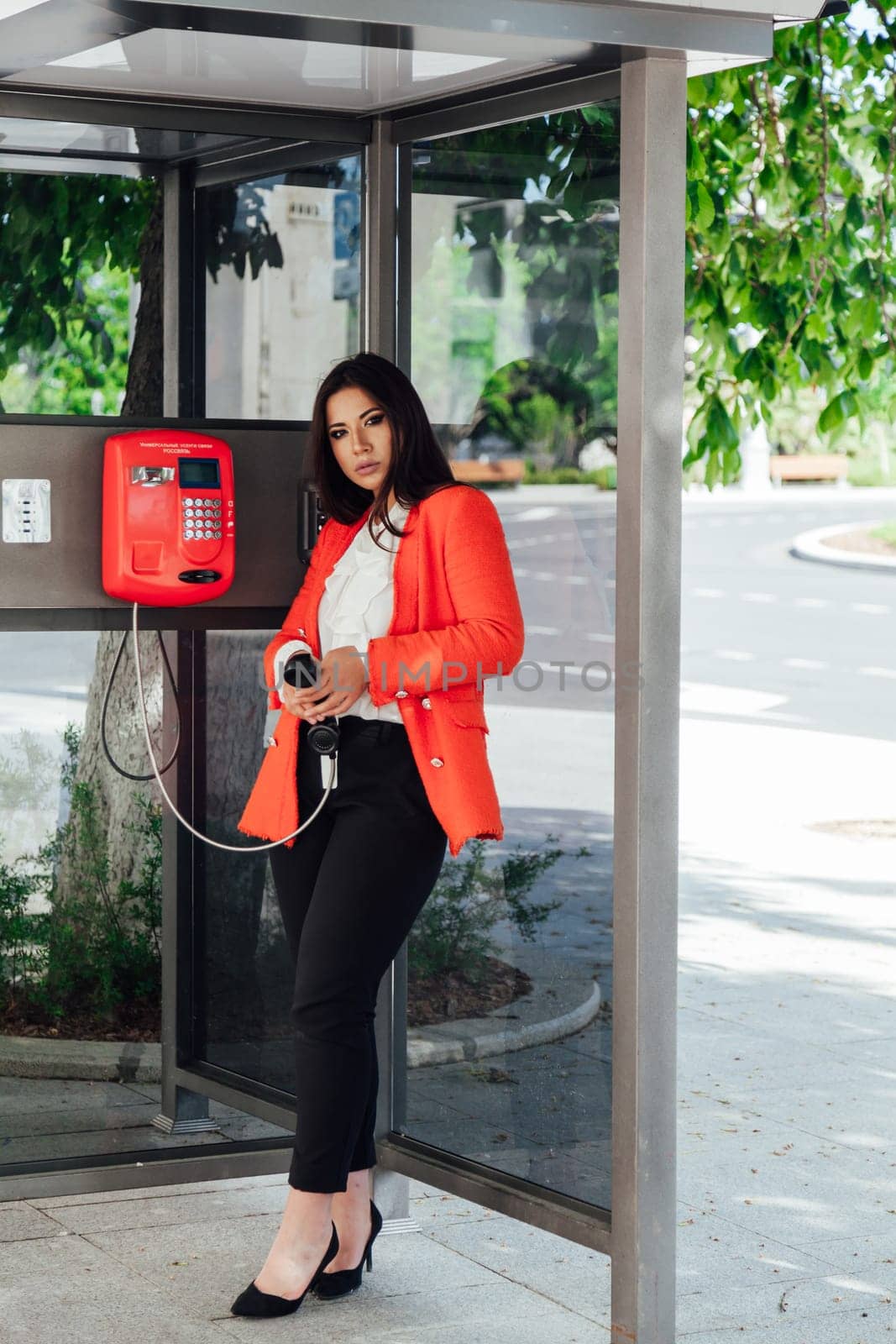 Young Woman next to London Traditional Telephone Booth