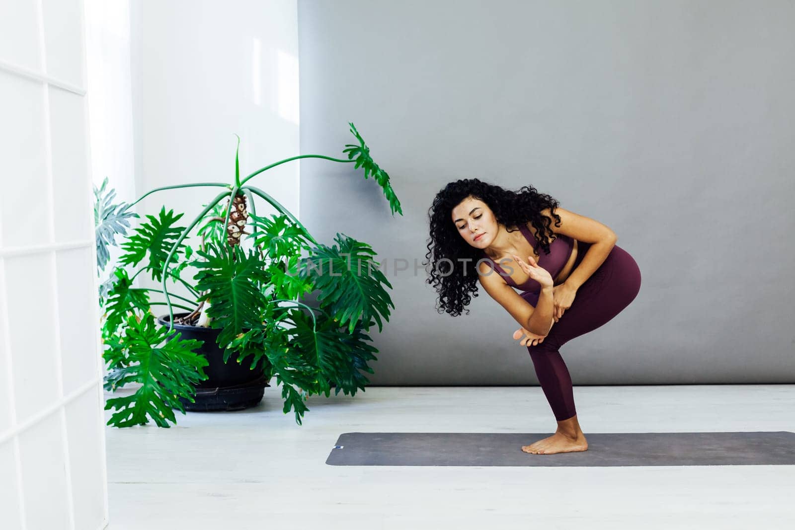 Beautiful woman yoga asana engaged in fitness gym by Simakov