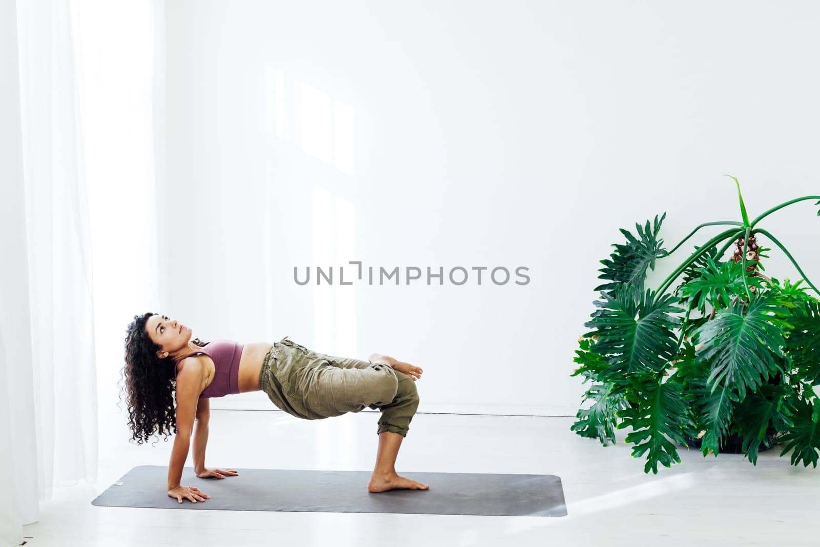 Beautiful woman yoga asana engaged in fitness gym by Simakov