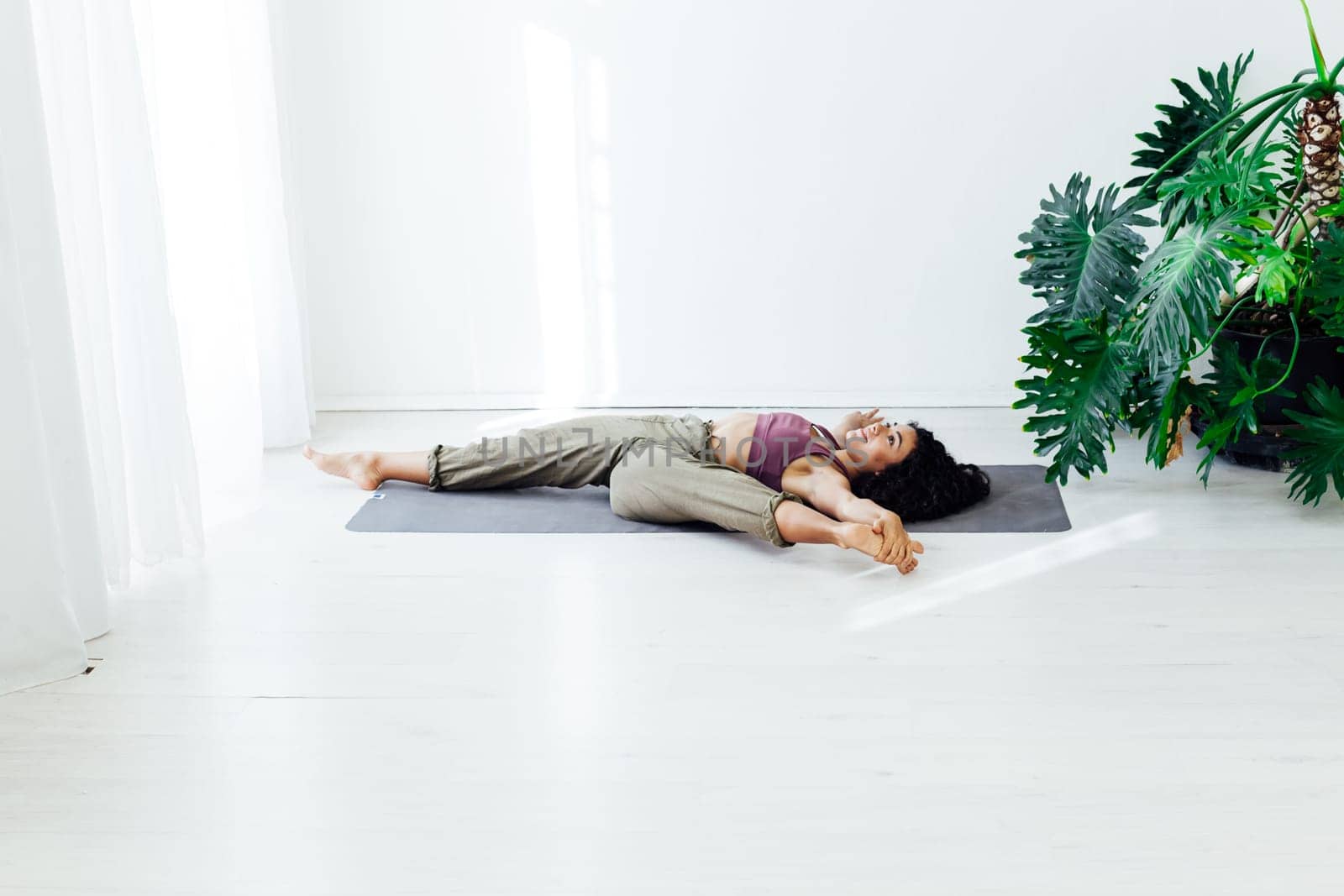 woman yoga asana engaged in fitness gym by Simakov