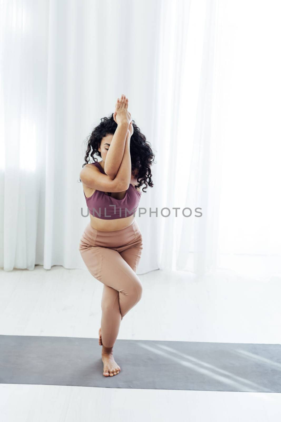 woman yoga asana engaged in fitness gym by Simakov