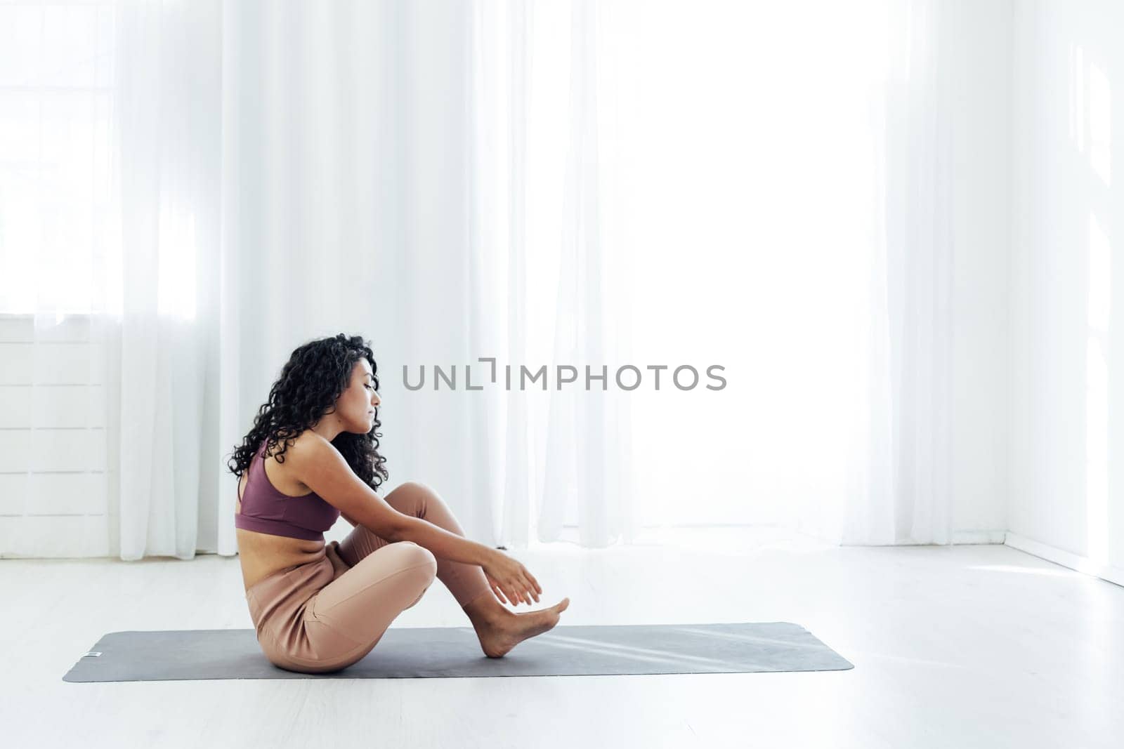 Beautiful woman yoga asana engaged in fitness gym
