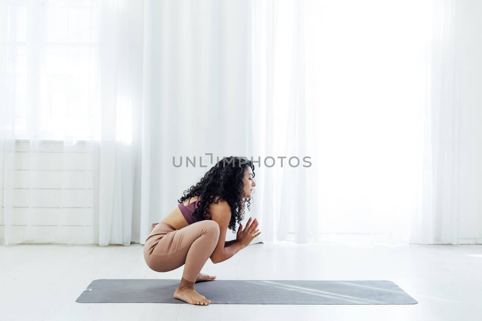 Beautiful woman yoga asana engaged in fitness gym