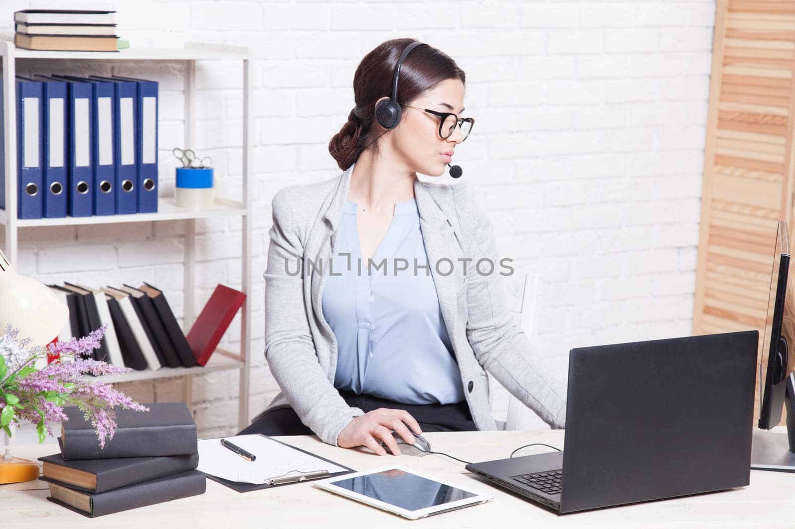 Call Center operator works at the computer in the Office 1