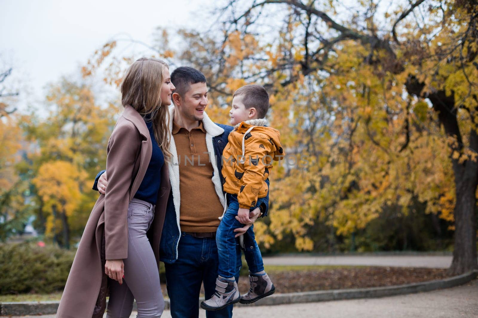 family mom dad son portrait with happiness in the forest 1