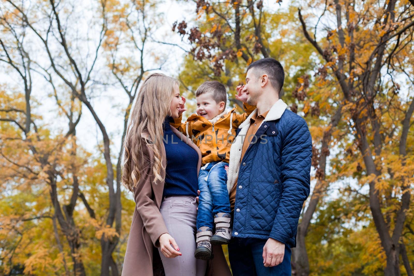 Happy family walks through the Park Winter forest by Simakov