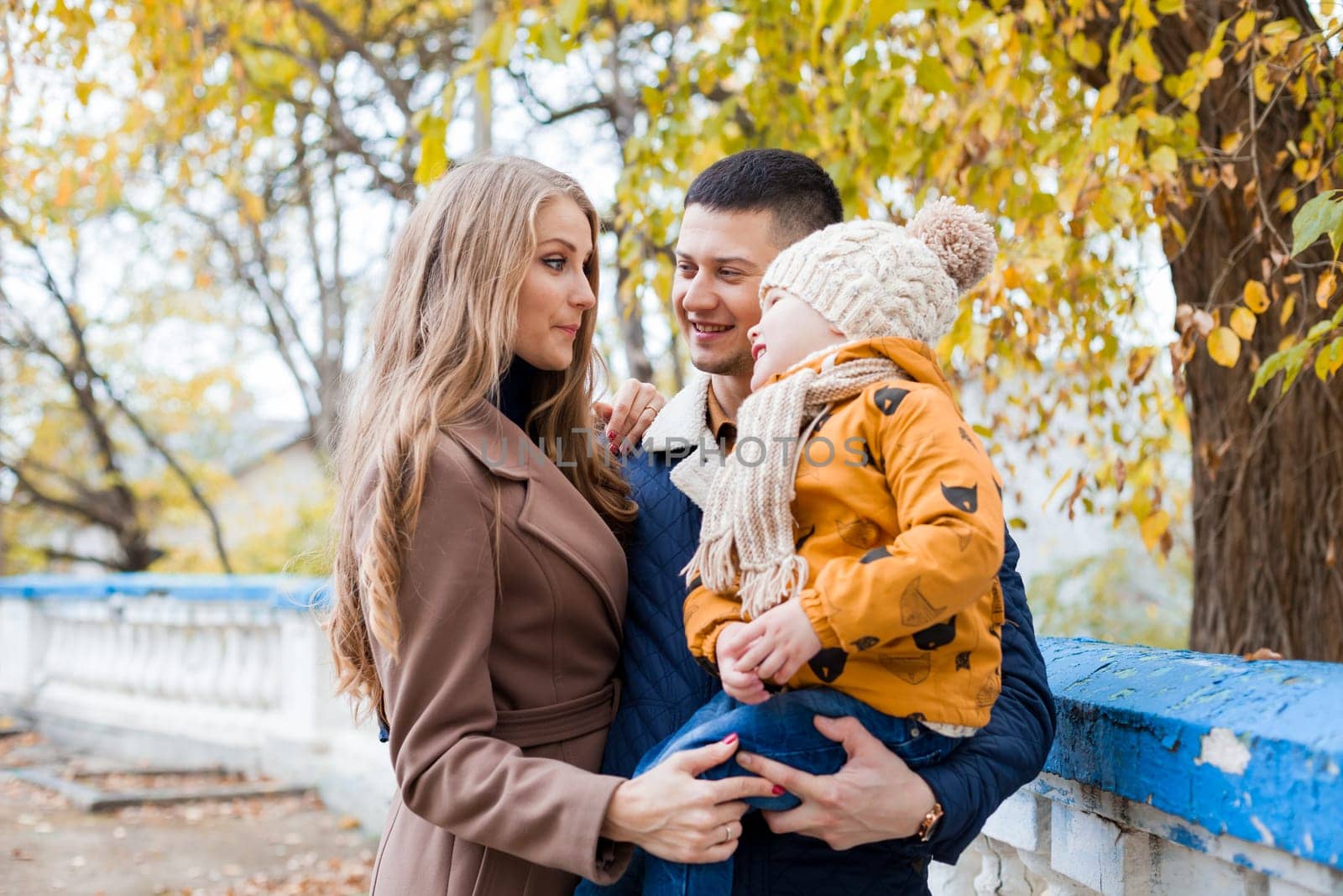 a family with a boy walking in the autumn Park happiness 1