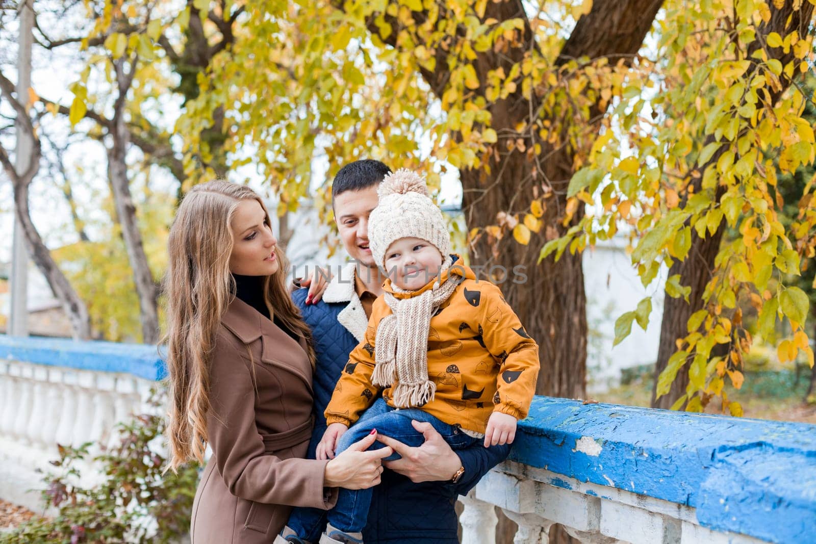 a family with a boy walking in the autumn Park happiness 1