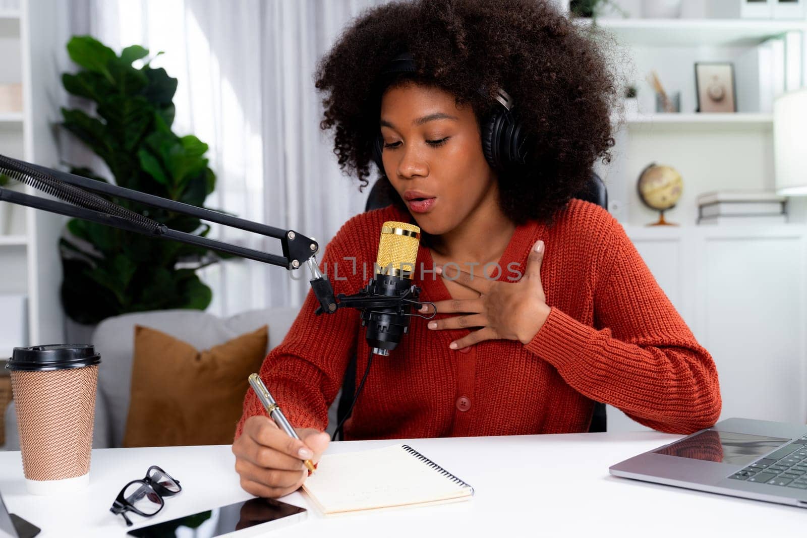 Host channel of African woman influencer talk and write story telling of listener in broadcast studio. Time slot of life coach consultant on social media online. Concept of giving advice. Tastemaker.