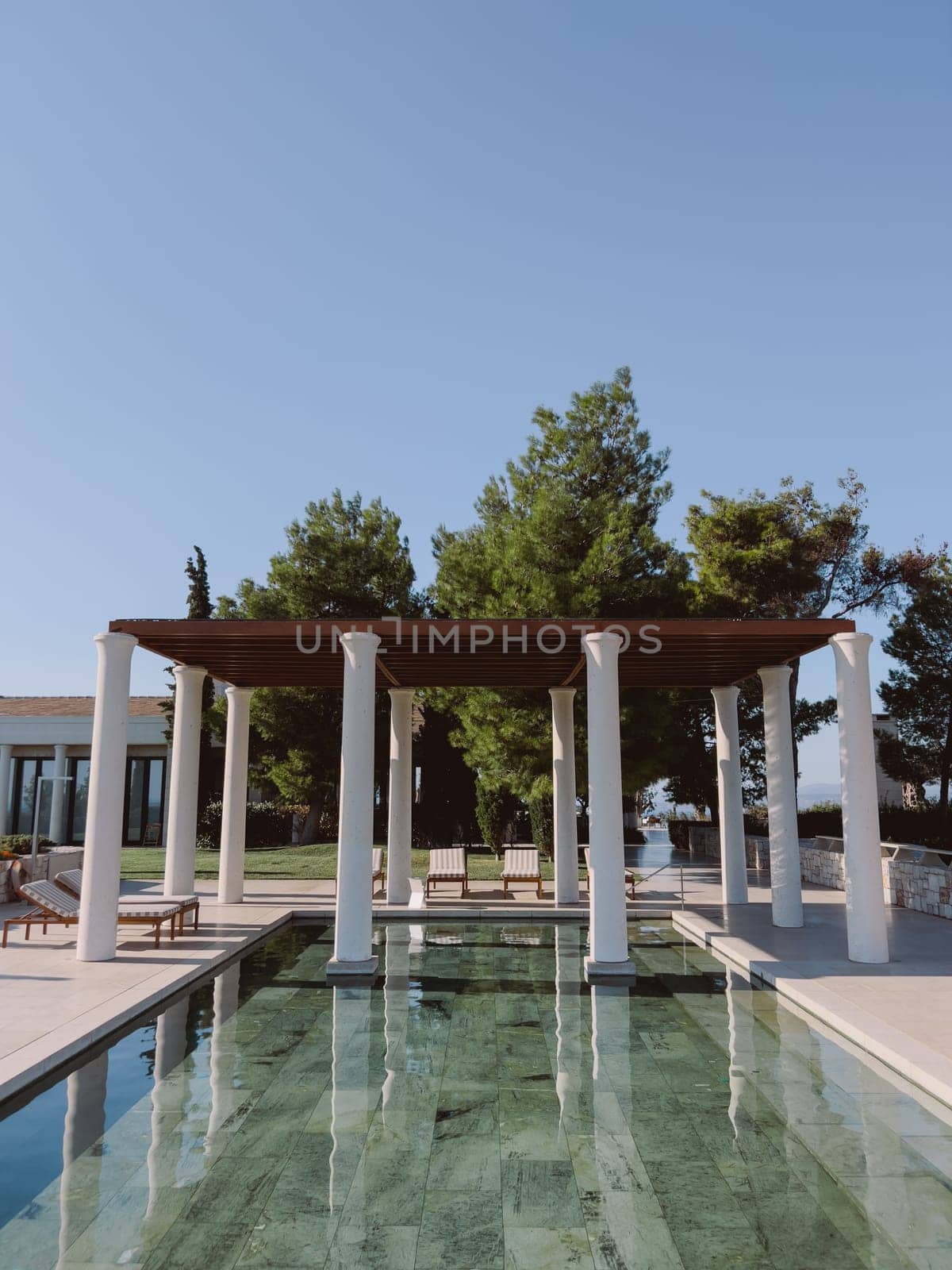 Pergola with columns near the pool. Hotel Amanzoe, Greece. High quality photo
