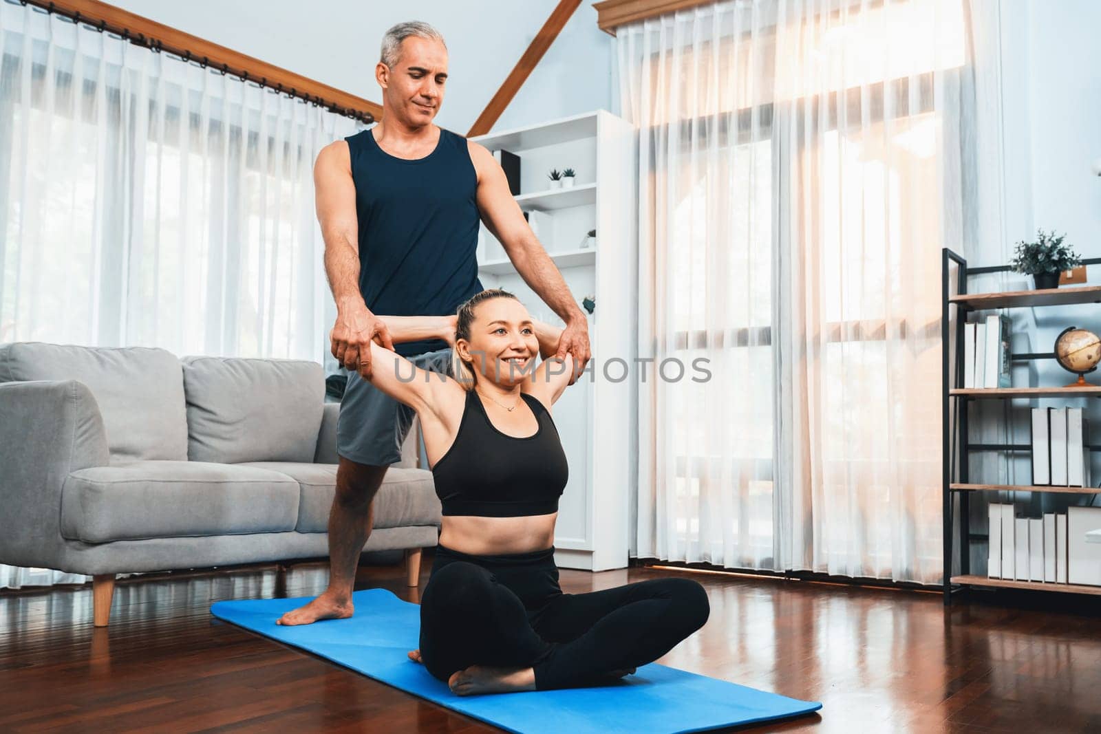 Happy active senior couple in sportswear doing yoga. Clout by biancoblue