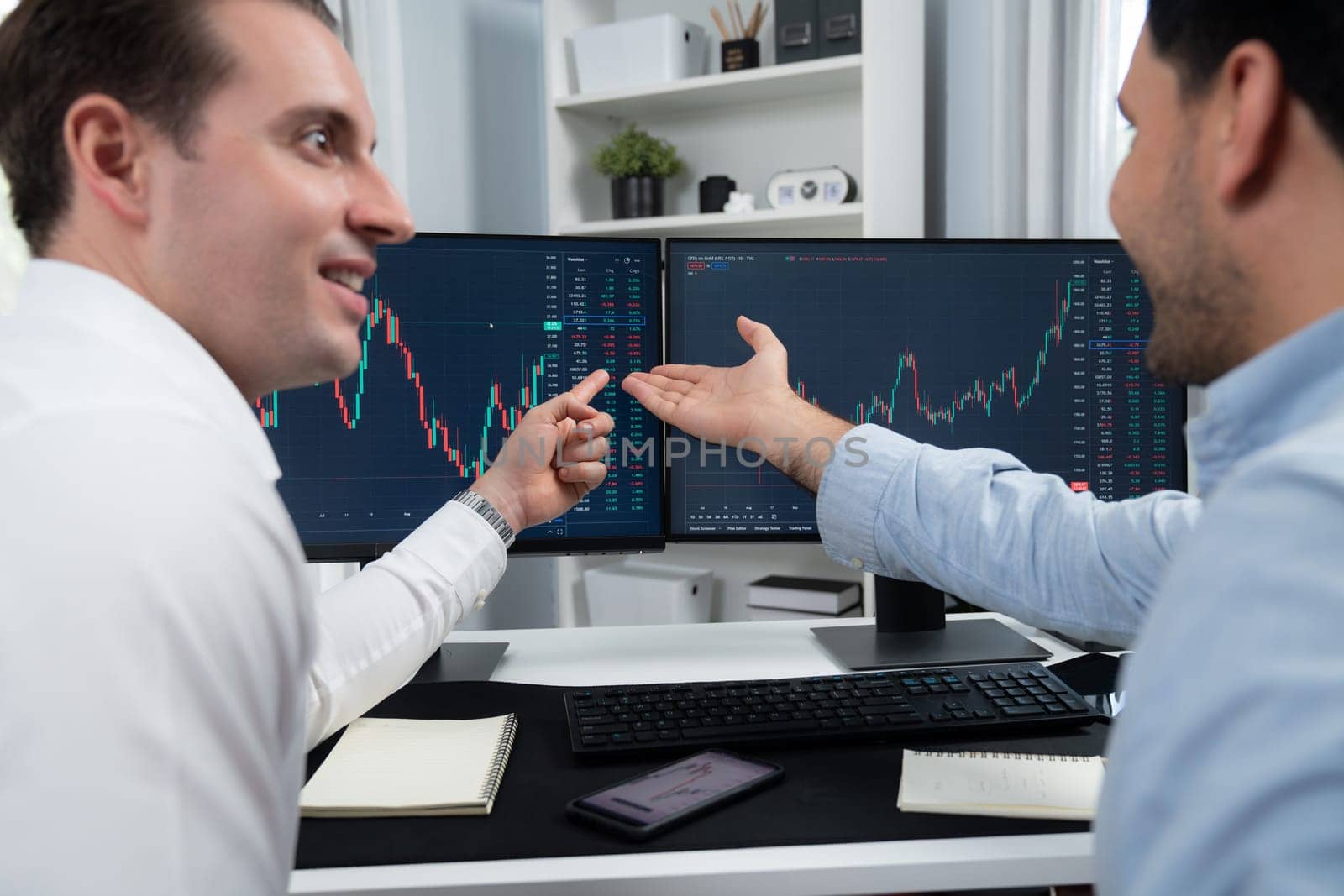 Successful stock exchange traders focusing on high profit chart investment on dynamic database, analyzing on monitor. Concept of discussing financial technology growth at workplace. Sellable.