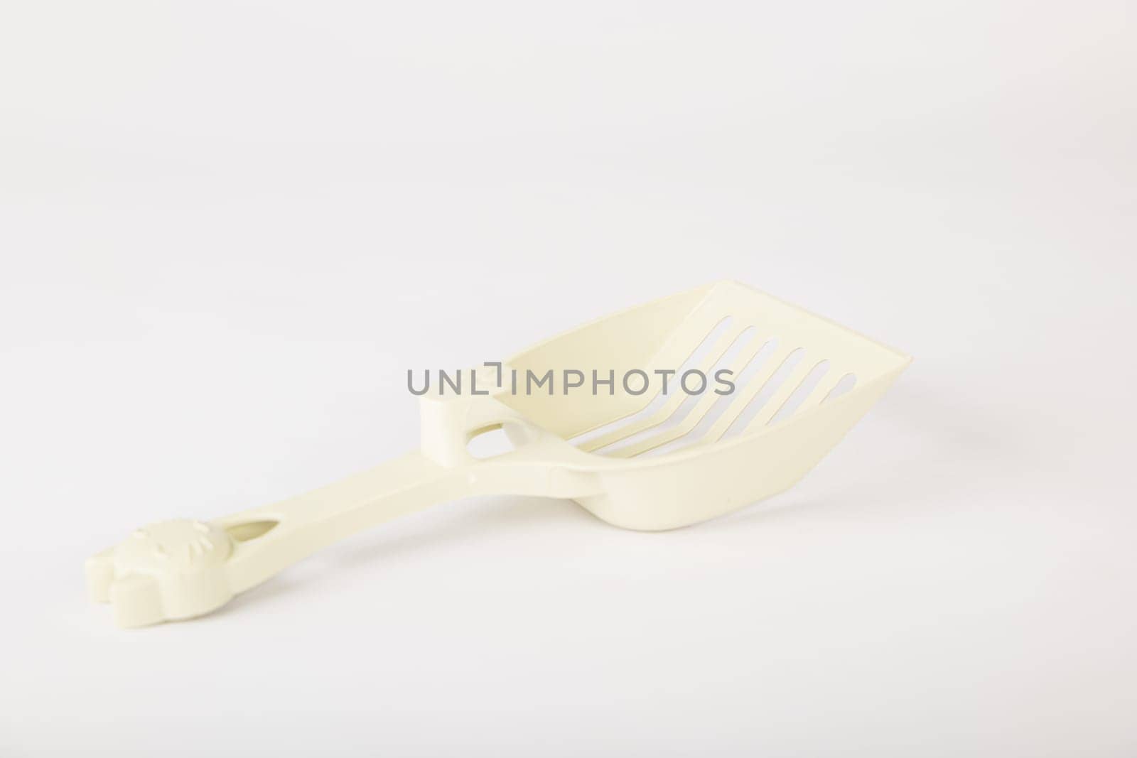 Isolated on a white background metal cat litter scoops are a must for maintaining hygiene and cleanliness in your cat's litter box. Purity and care in one simple tool.