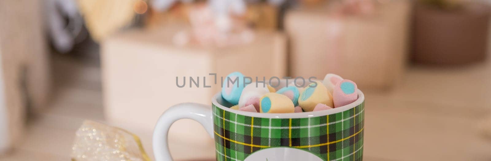 Close-up image, A tasty hot melted chocolate with tiny marshmallows cup in a woman's hand. Winter drinks concept