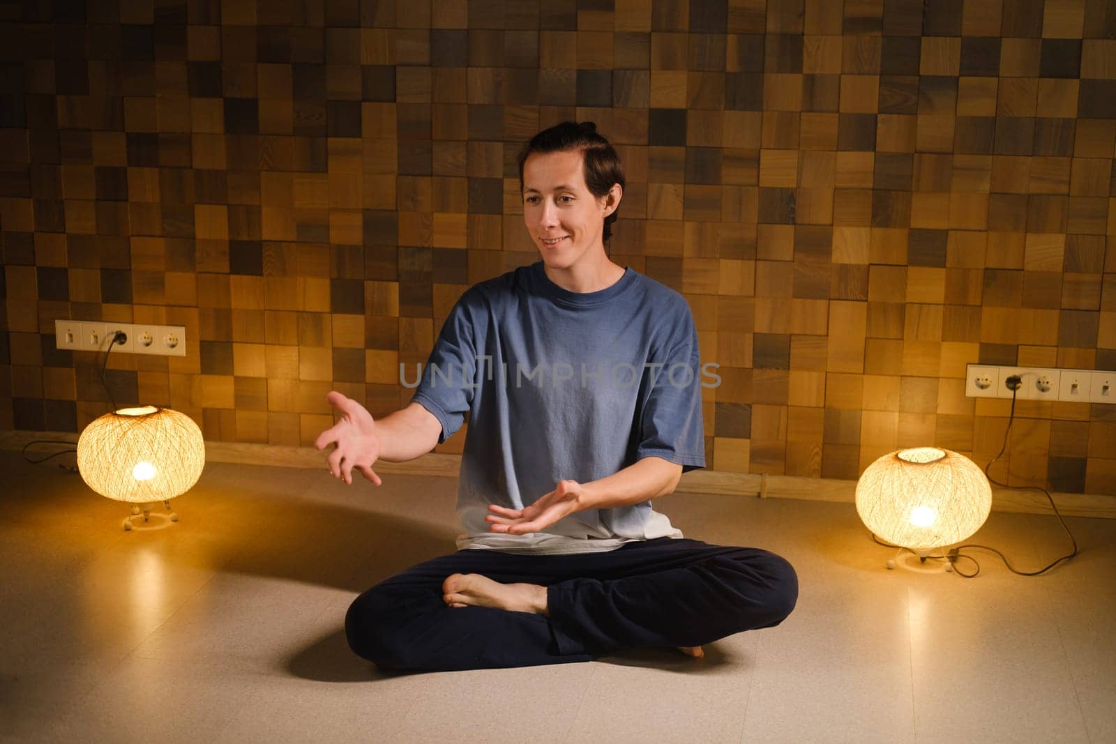 a man in a sports uniform does yoga in a fitness room. the concept of a healthy lifestyle.