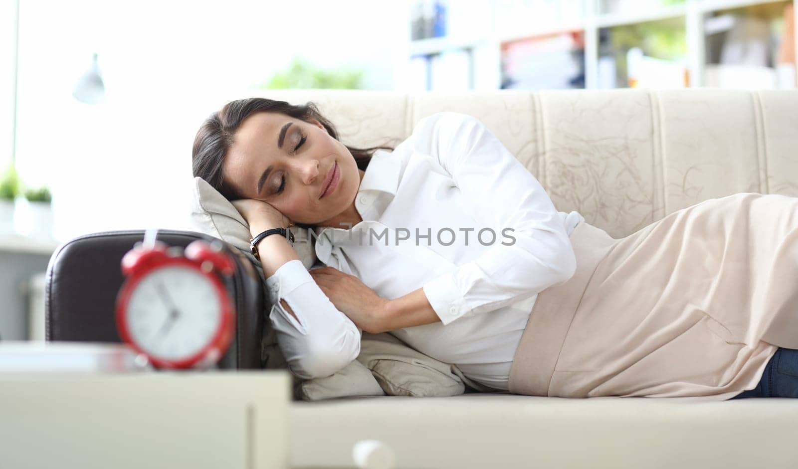 Beautiful young woman sleeps serenely on couch. Daytime nap rest and break