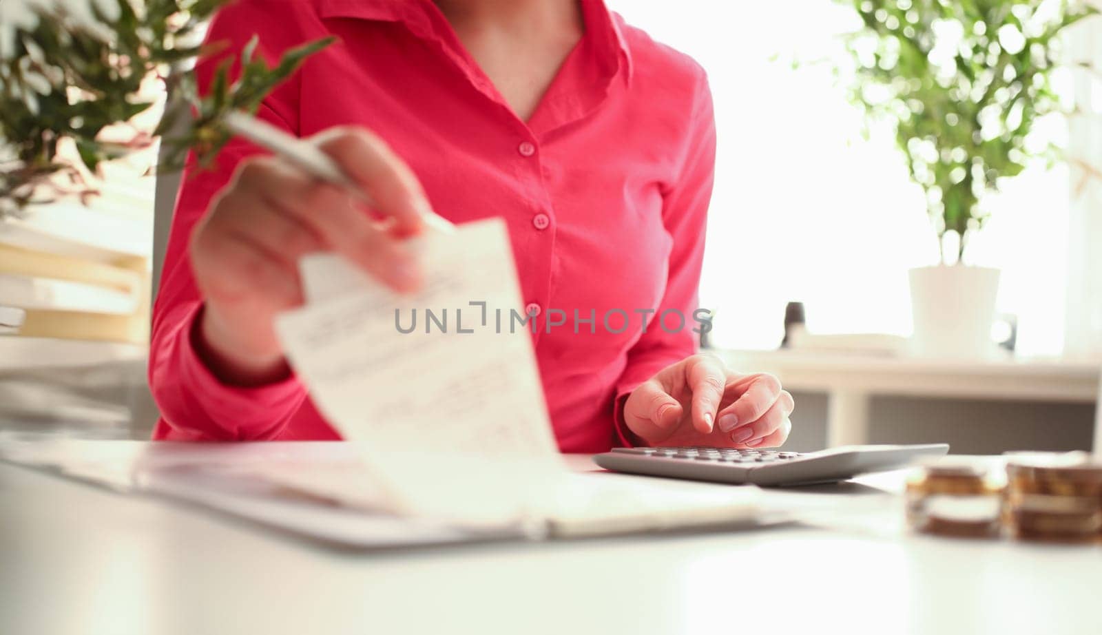 Woman hands holding calculator and paid check closeup. Working as financial secretary and family and business budget expenses