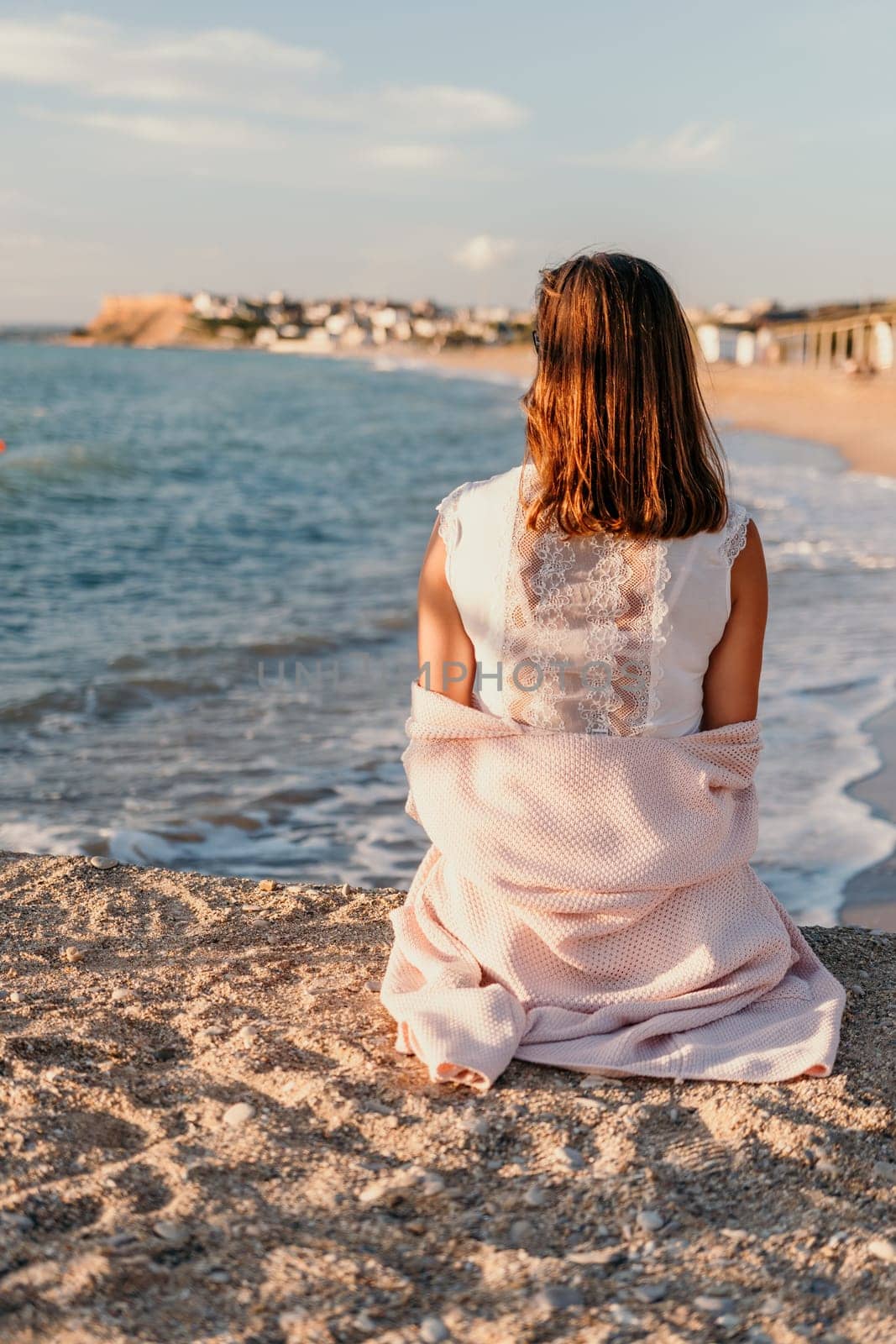 Woman summer travel sea. Happy tourist enjoy taking picture outdoors for memories. Carefree woman traveler posing on beach at sea on sunset, sharing travel adventure journey. Holiday vacation concept. by panophotograph