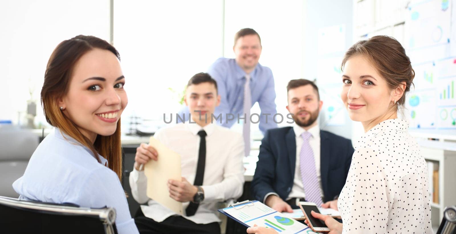 Mentor manager speaks at executive team meeting in boardroom. Mentor trains executive team at board briefing and business people discuss strategy in office