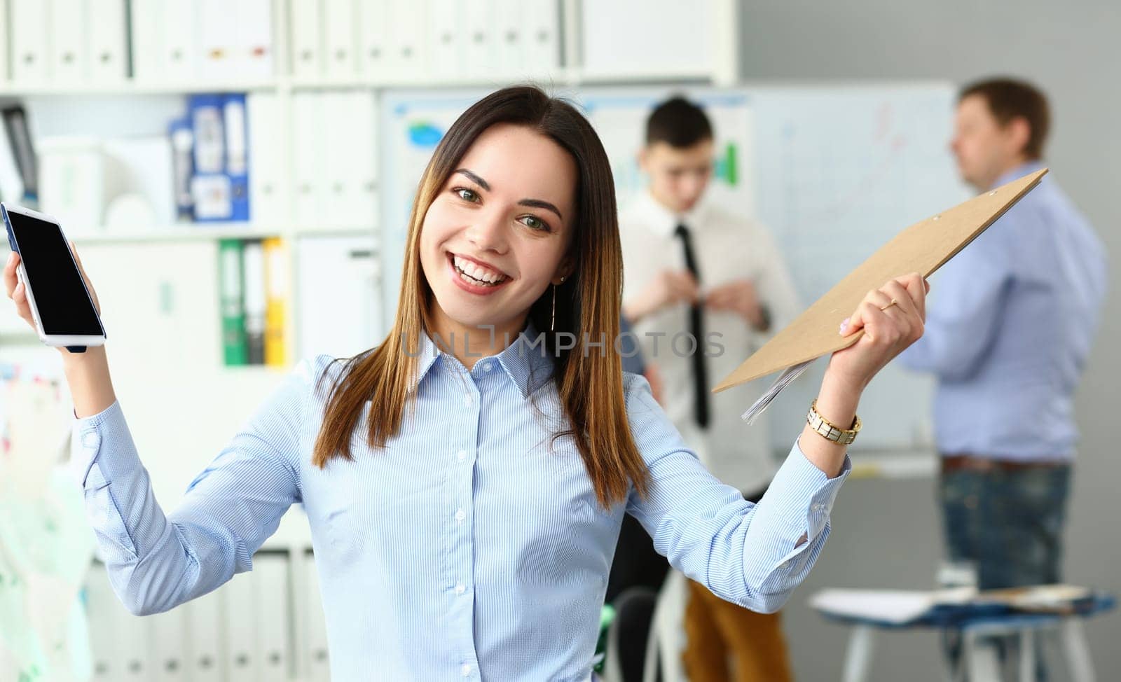 Portrait of a joyful smiling beautiful businesswoman in office by kuprevich
