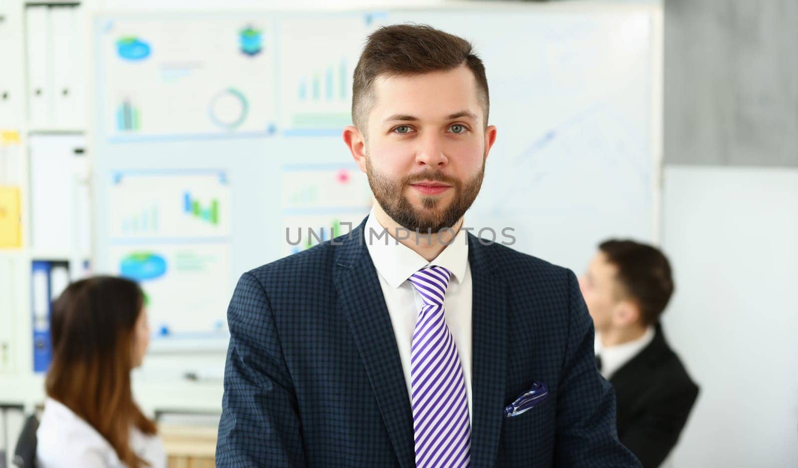 Portrait of a young smiling businessman successful entrepreneur winning meeting by kuprevich