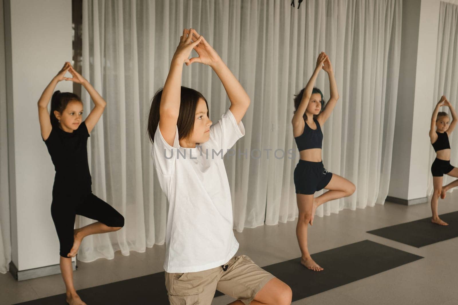 Children do Yoga in the fitness room. Children's gymnastics.