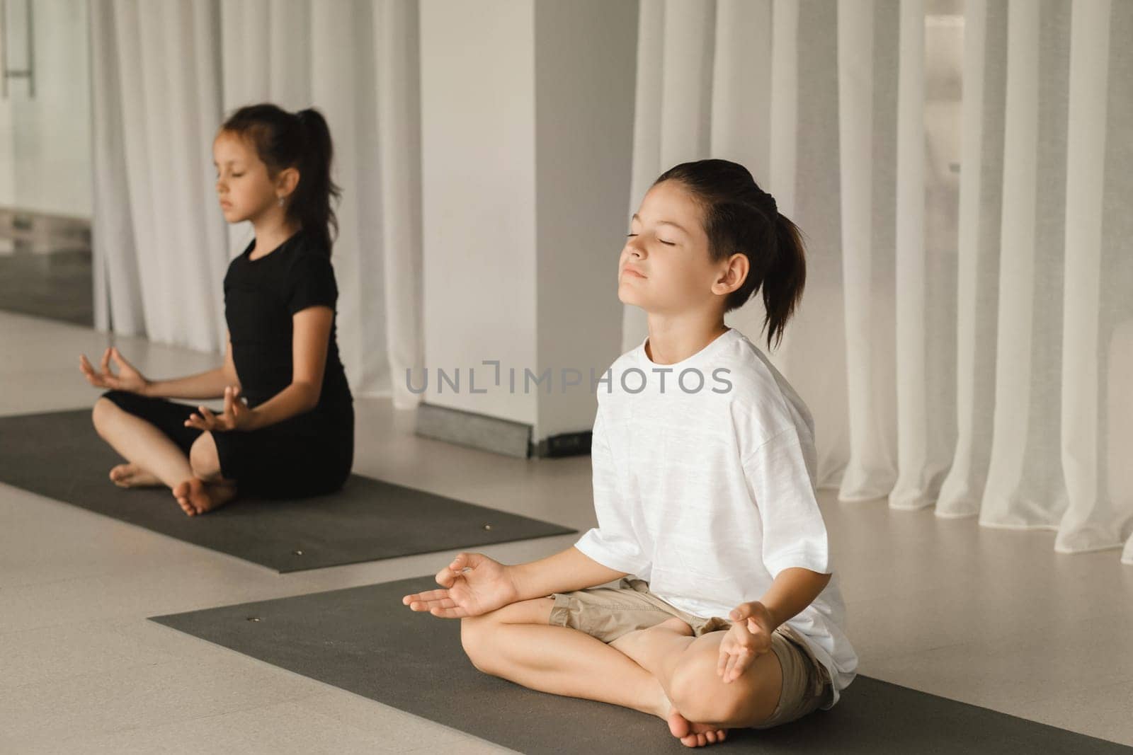 Children do Yoga in the fitness room. Children's gymnastics..