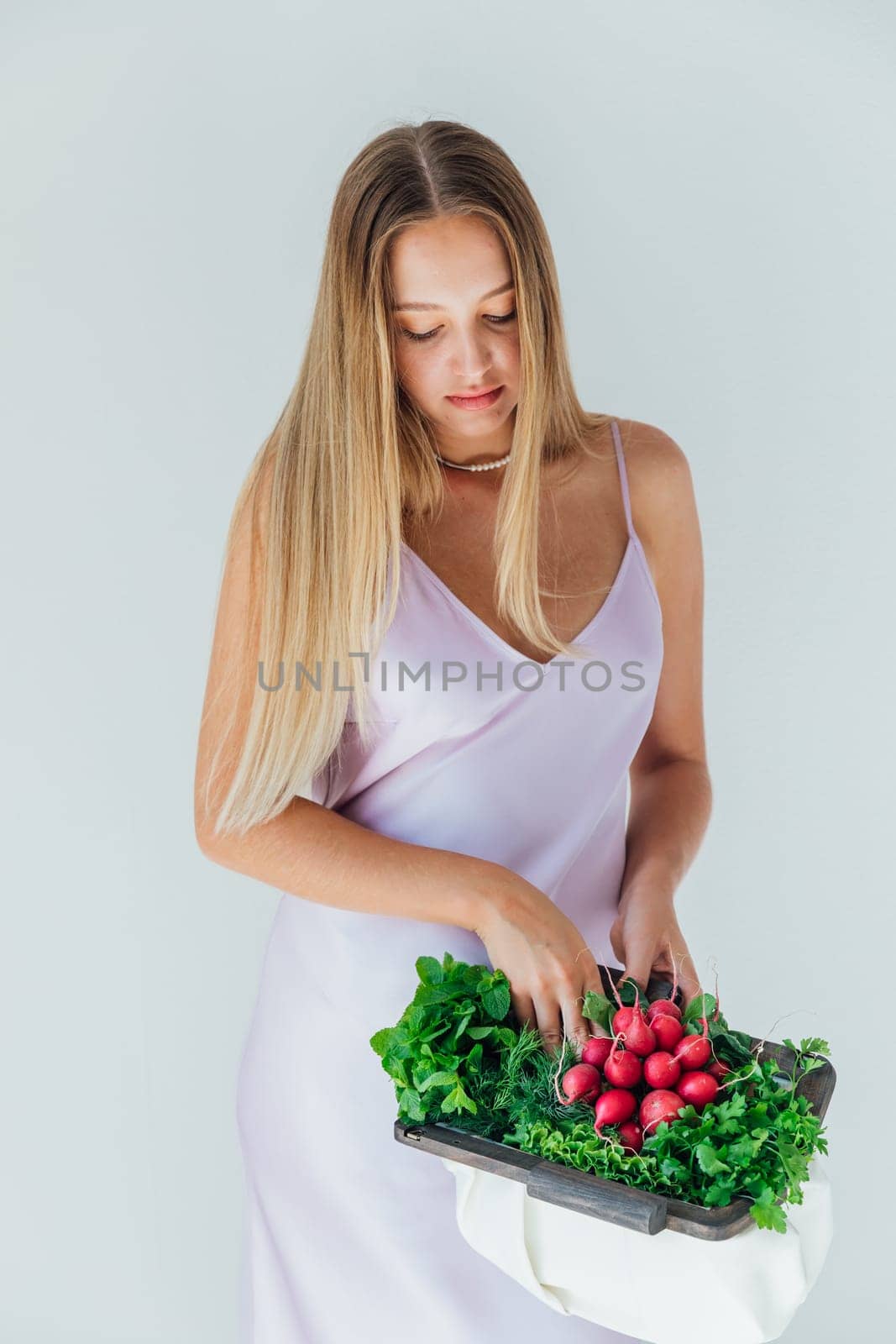 Female nutritionist holding bag with vegetables for eating by Simakov