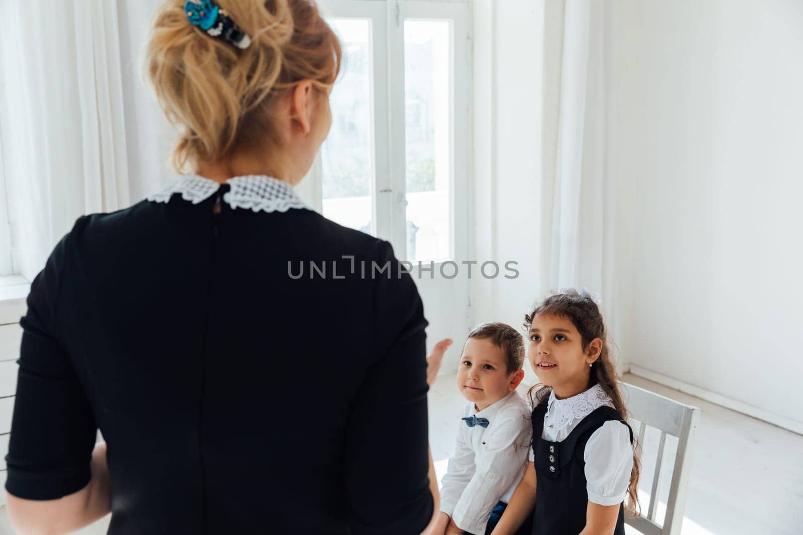 teacher at lesson at school with children and books