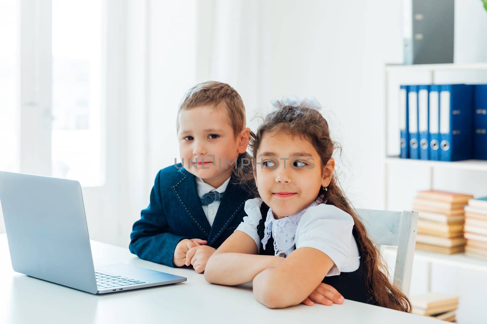 Boy and girl studying at the computer online
