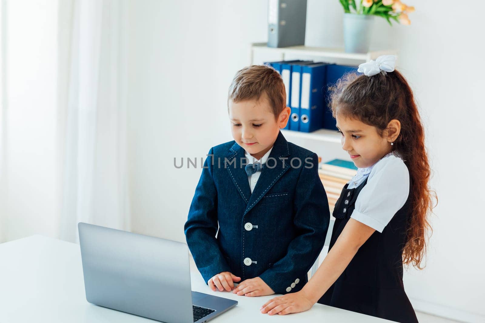 Boy and girl studying at the computer online