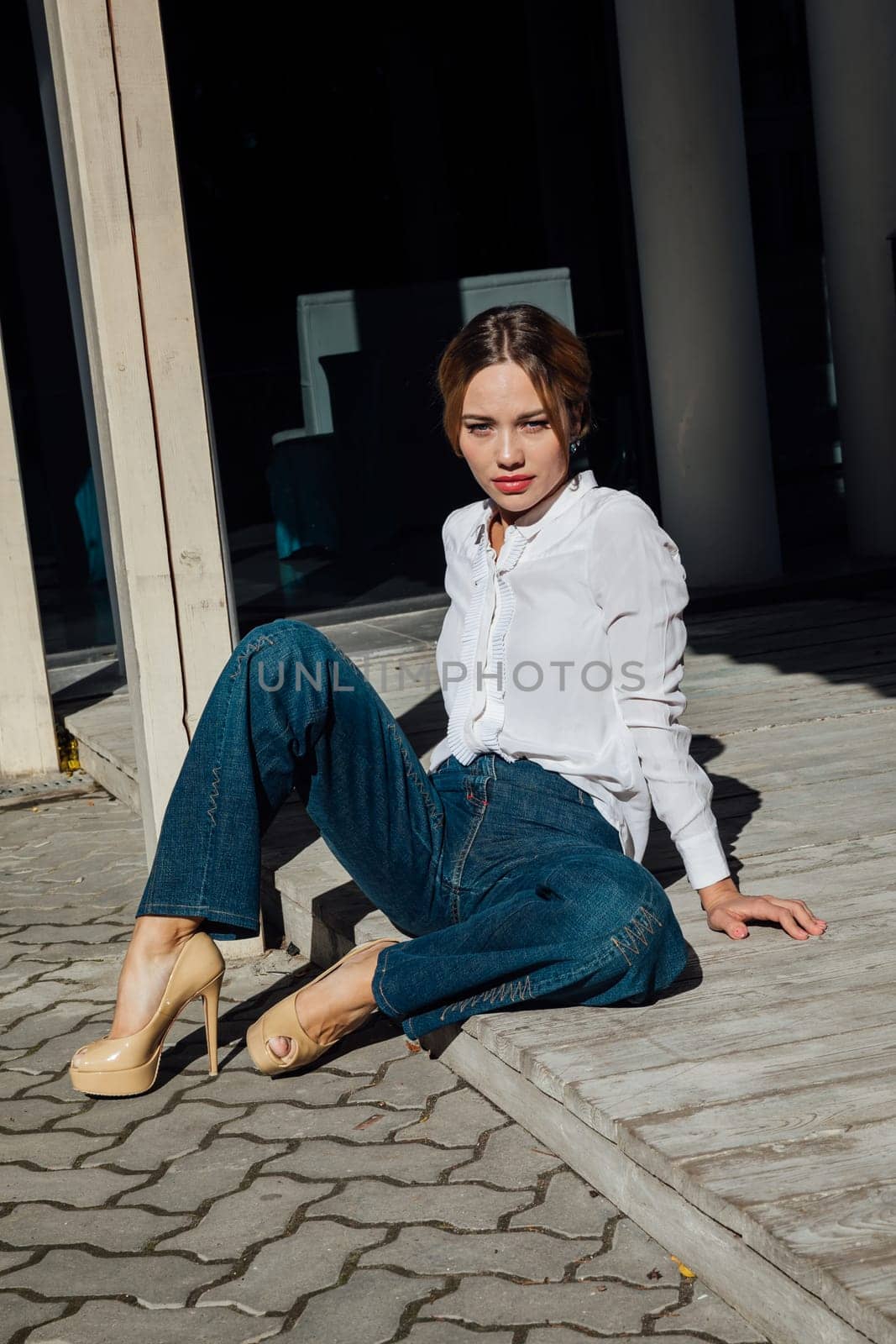 Beautiful fashionable woman on wooden floor on walk by Simakov