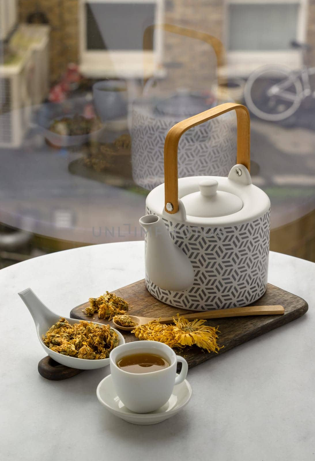 Chinese chrysanthemum flower tea and Dried chrysanthemum flower on wooden cutting board. Healthy beverage for drink. Herbs and medical concept. Copy space, Selective focus.