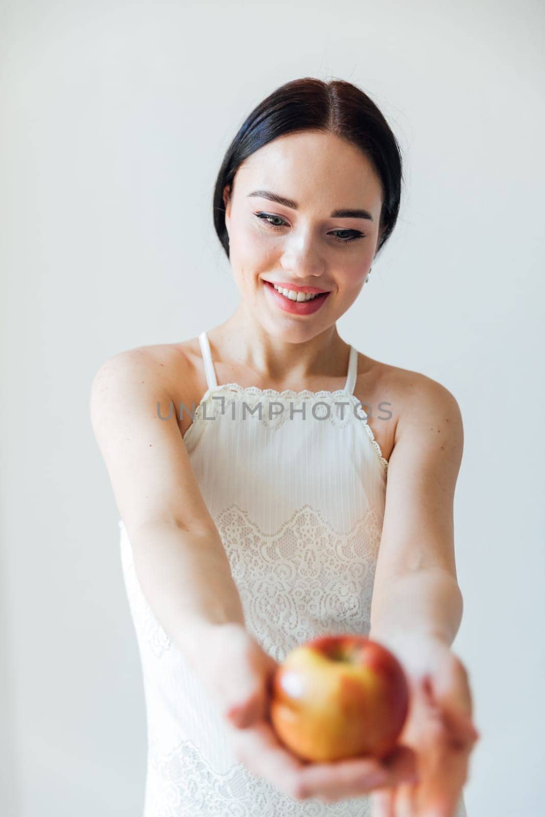 brunette woman with apple in bright room